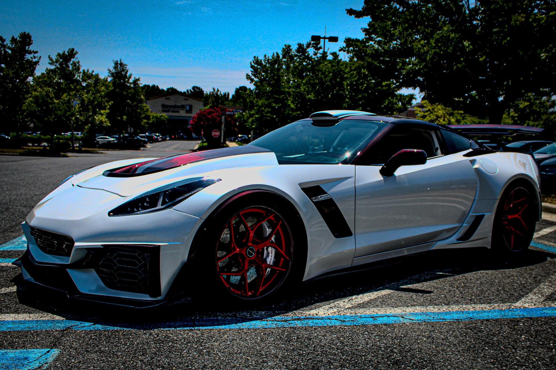 Corvette ZR1 with red forged wheels in midday sun